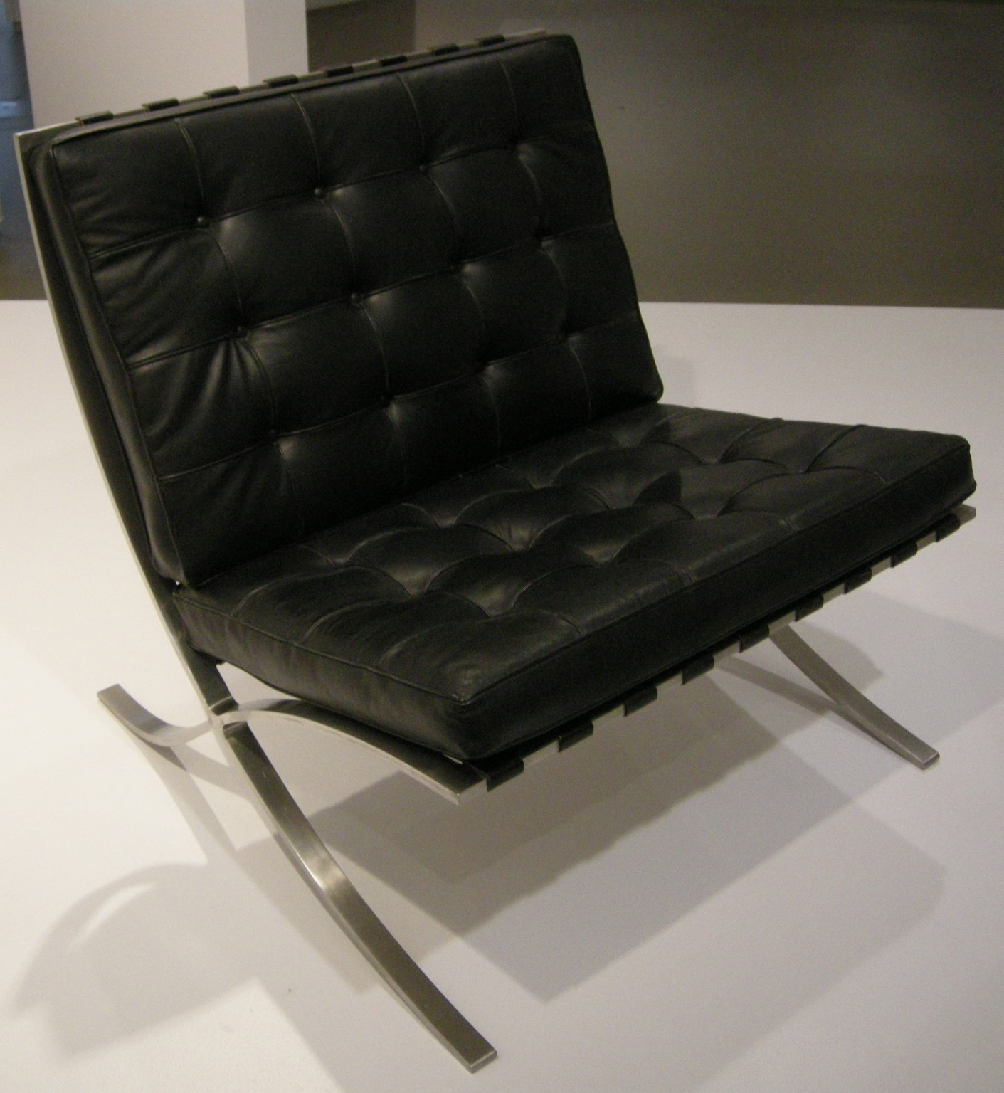 Close-up of the Barcelona Chair showing leather paneling and frame finish
