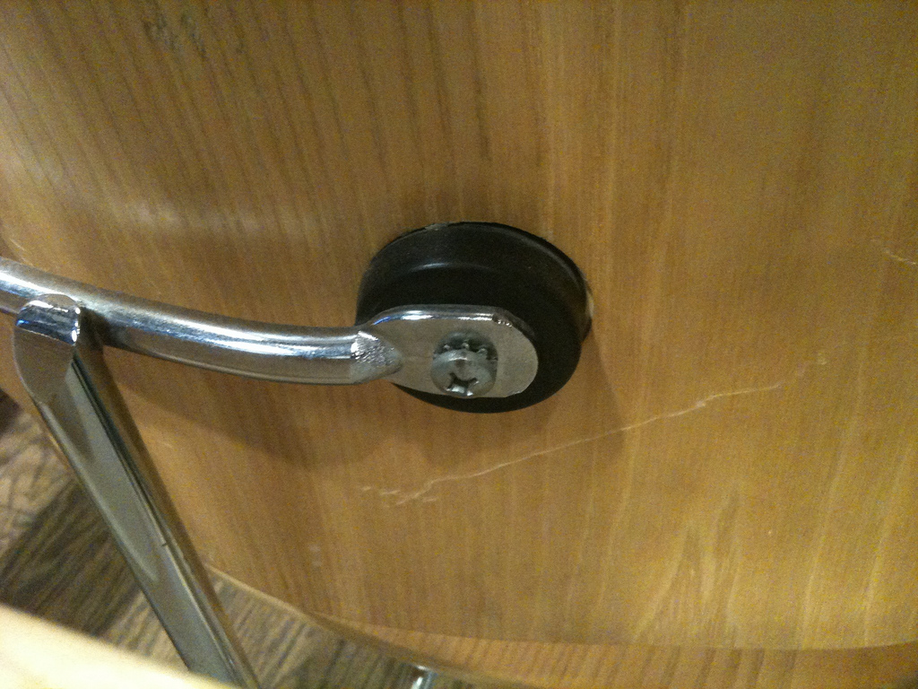 Close-up of an Eames LCW shock mount showing the rubber and wood connection detail