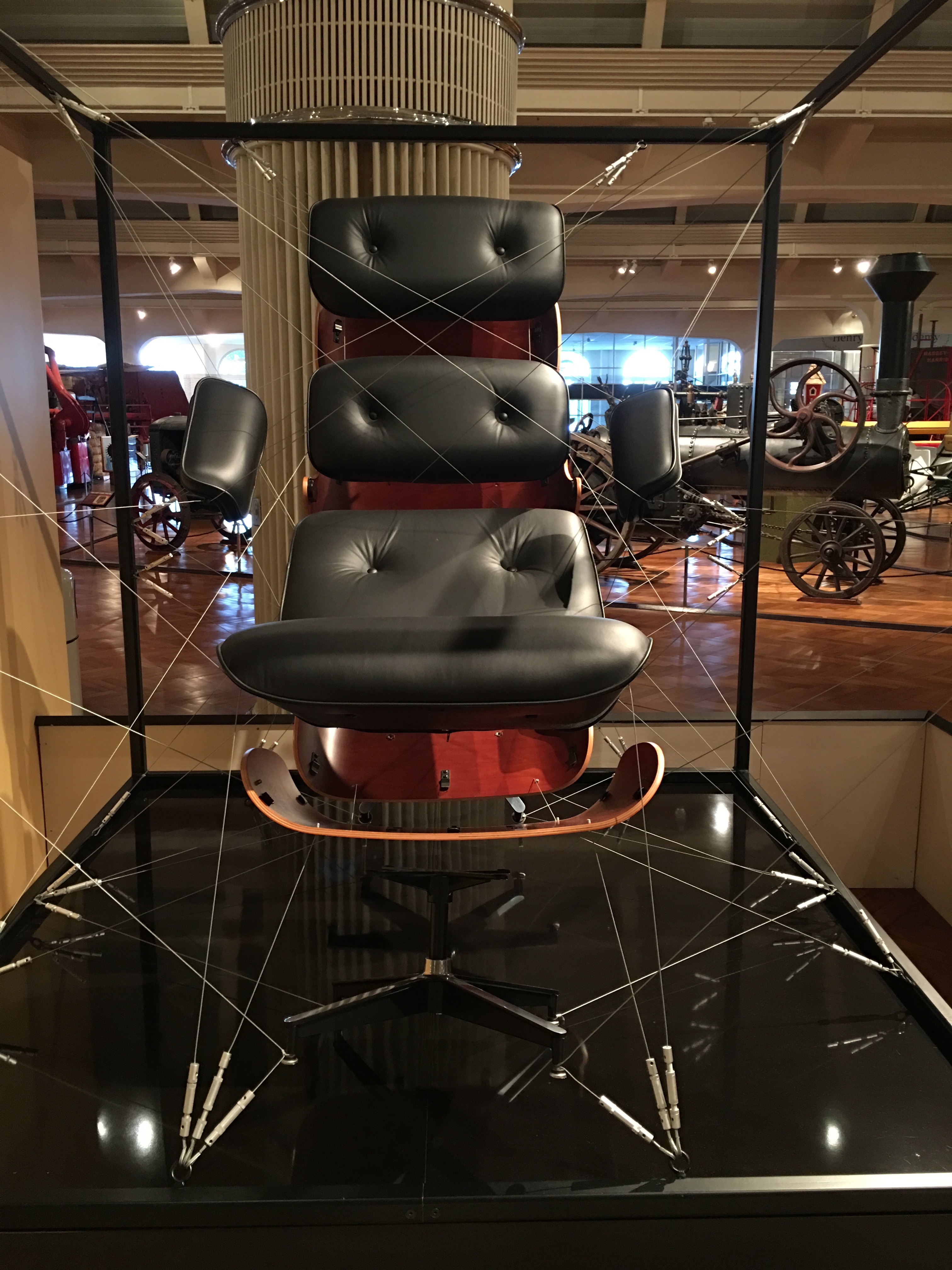 Exploded Eames Lounge Chair and Ottoman installation showing component layering and construction